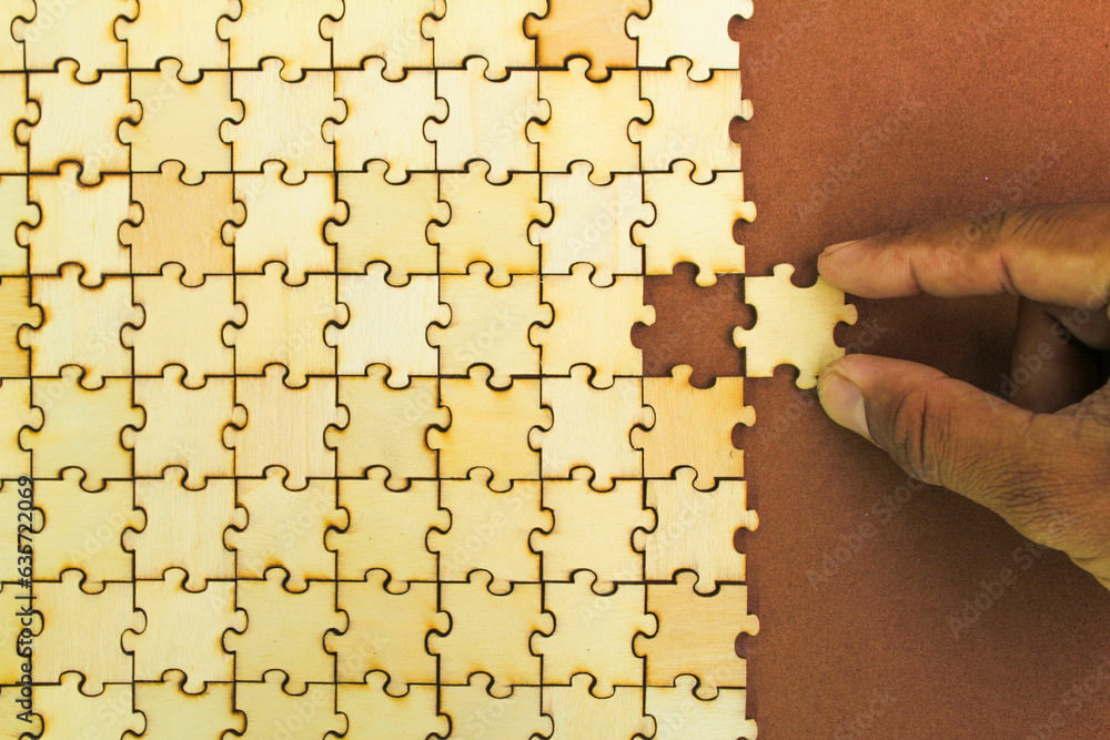 Poster hand holding the last puzzle to be solved or finished. compliting final task. logical thinking, busi
