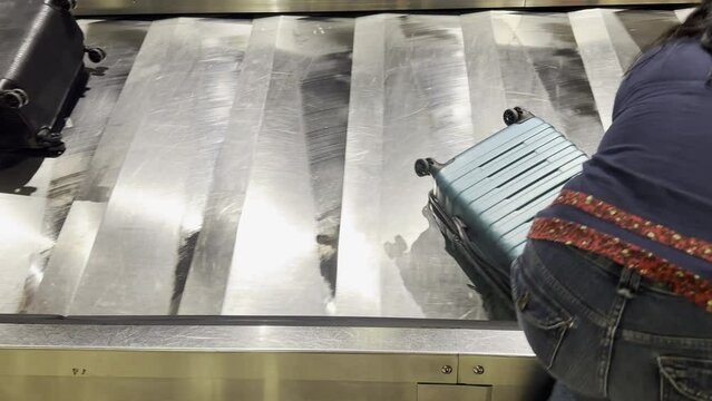 Banda metalica de recolección de maletas en aeropuerto en movimiento