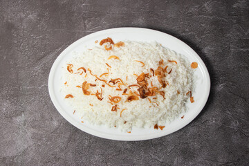 Plain Polao or boiled pulao rice with fried onion served in dish isolated on background top view of...