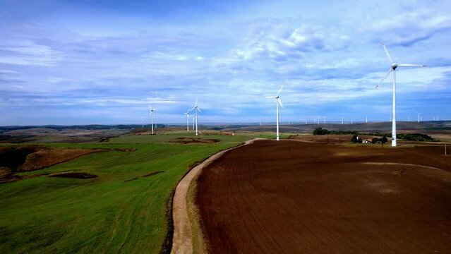 Maintenance road leading to wind turbine park, aerial view