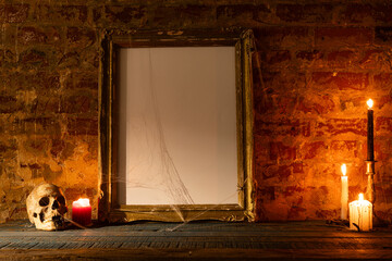 Black frame with copy space, skull, candles and smoke on brick wall background
