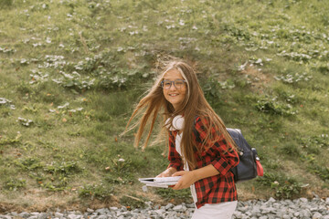 happy teen girl student in headphones street style portrait