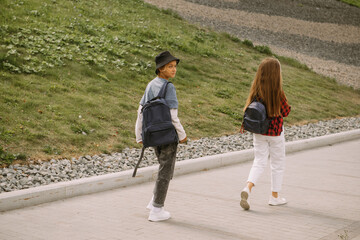 teenage boy and girl outdoors portrait, communicating and walking together