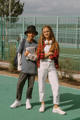 teenage boy and girl outdoors portrait, communicating and walking together