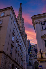 August 5, 2023, Vienna, Austria, old town street and spire of St. Stephen's Cathedral and Habsburg crypt at sunset