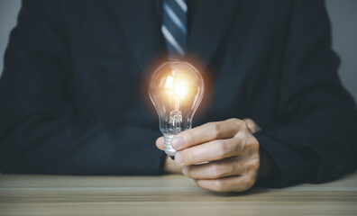 businessman holding a light bulb Digital technology. idea creative	
