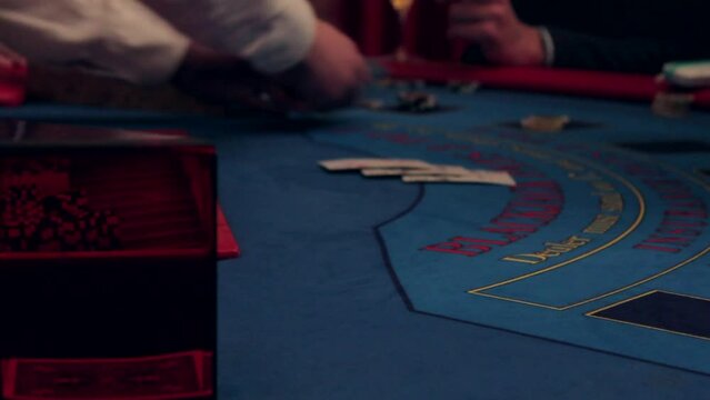 Playing a casino on the table, distribution of cards. Card issuance at casino poker