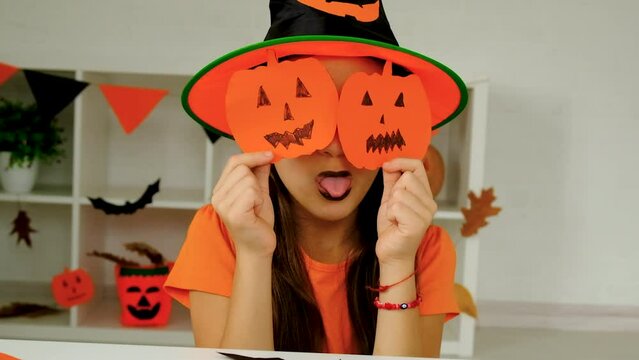 Halloween holiday child and pumpkin. Selective focus.