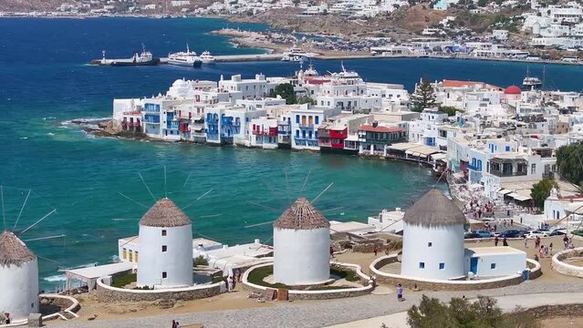 Aerial view through the famous windmills above Mykonos town, Cyclades, Greece, to the Little Venice district during summer time