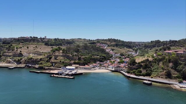 Drone shot reversing out over the river from Porto Brandao in Portugal.