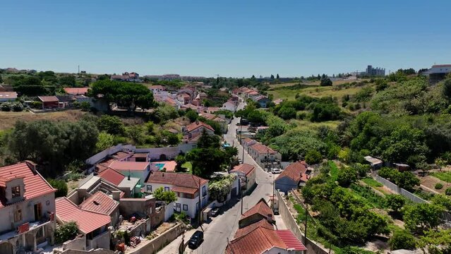 Drone flying up the hill over the road and the hills at Porto Brandao,Portugal.