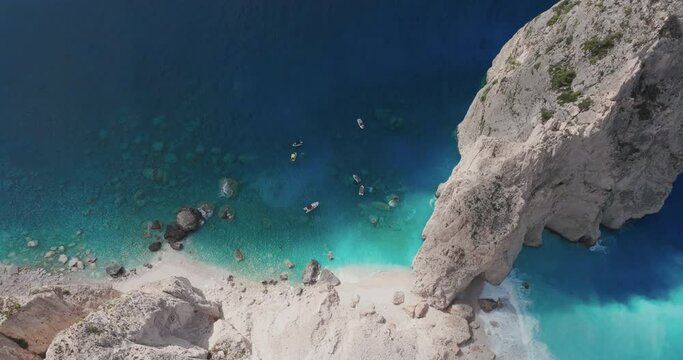 Top View of Boats in Blue Water Under Cliffs of Zakynthos Island, Greece on Sunny Summer Day