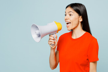 Young shocked latin woman wear orange red t-shirt casual clothes hold in hand megaphone scream...