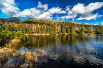 Mountain lake called Jamske pleso in autumn colors with peak Krivan at background. Slovakia
