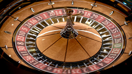 Roulette table in a casino, with many games and slots, roulette wheel in the foreground. Golden and luxurious light, casino interior. Gambling is betting on money or gambling for money.