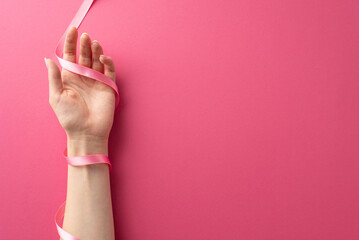 Breast Cancer Awareness Month theme. Top view image featuring a woman's hands cradling a pink...