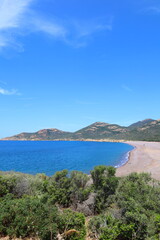 Naklejka na ściany i meble Panoramic view of the black sands of Galéria beach, turquoise Mediterranean sea and the Fango river in Corsica