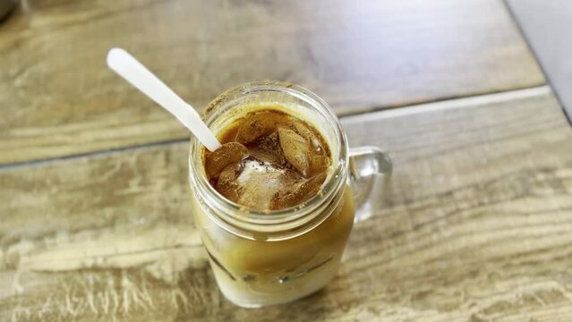 dirty iced chai latte in a mason jar on table top, cinnamon, cacao, chai, latte, tea, delicious, treat yourself, food concept, cheatday, sweet tooth, straw, chai latte, chai drink.