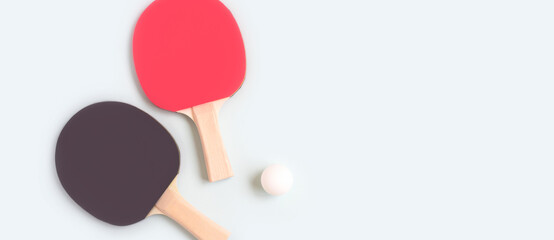 Banner with tennis rackets and ball on a blue background. Ping pong concept with copy space.