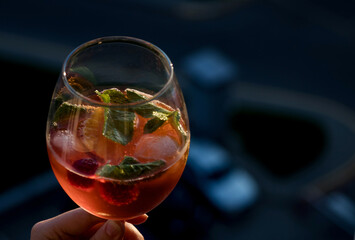 hand holding glass with cocktail.
