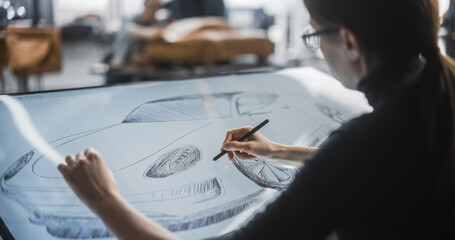 Female Automotive Designer Using a Digital Tablet to Draw a Prototype Car Sketch. Focused Industrial Artist Working in a Research and Development Studio at a Vehicle Production Factory