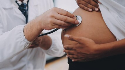 Happy pregnant woman visit gynecologist doctor at hospital or medical clinic for pregnancy consultant. Doctor examine pregnant belly for baby and mother healthcare check up. Gynecology concept.