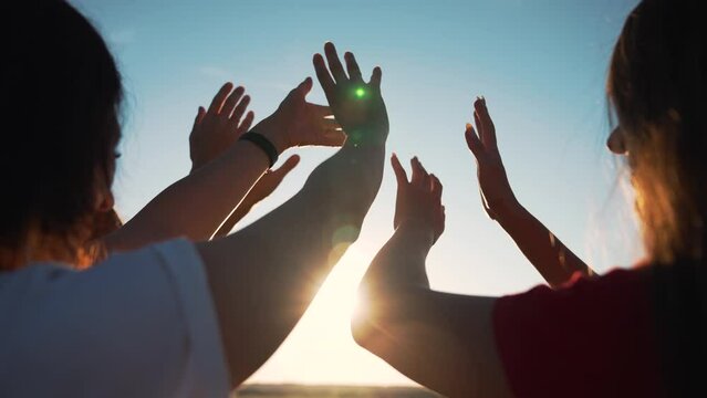 Group of people pulls their hands to sun sky. Teamwork religion and belief. Group of people stretch their hands up. Summer vacation and travel people. Team summer vacation. Group of friends teamwork
