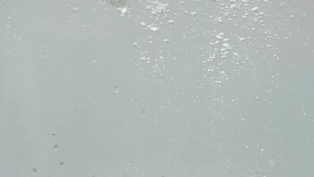 View of bubbles forming in sparkling water