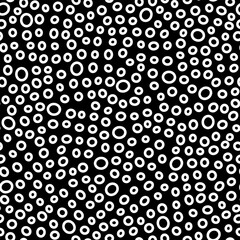 Seamless rings pattern. Small white hand-drawn oval on dark black background. Doodle dots cozy ovate ornament. Vector dotted illustrations with circles for wallpaper, posters, wrapping paper, fabric