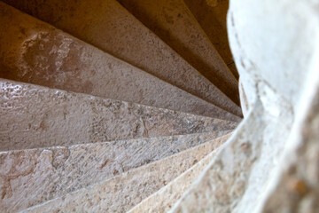 Close up shot of a stone spiral staircase in a French building