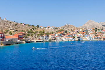 Fototapeta na wymiar Charming Colors of Chalki: Exploring a Picturesque Island Harbor in Greece