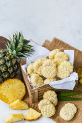 Homemade butter cookies with pineapple jam inside, Photographed with natural light. Selective Focus. White textured background.