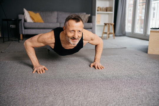 Active Senior Man Doing Yoga in His Apartment