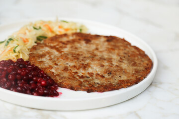 Homemade potato pancake with sauerkraut and cranberry