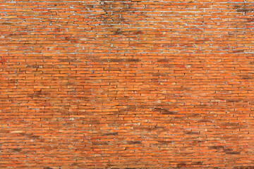 Closeup of old texture of orange and red stone wall blocks 