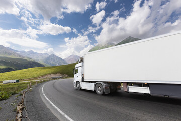 semi truck driving through mountain road pass - 635785099