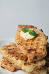 Croissant waffle or croffle on white plate. Croffle is Korean-influenced street food which become popular and trend in Indonesia now-days