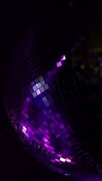 Rotating mirror disco ball. Dancing or party concepts. Vertical video background.