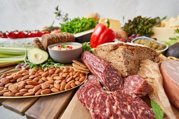 Salami and Parma sausage close-up. Table full of mediterranean appetizers, tapas or antipasto. Assorted Italian food set. Delicious snack on party or picnic time. Meat and cheese. 