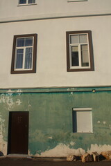 stones near the house of a contrasting color, windows with white shutters, sea trip mood, mint and white color