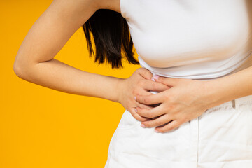 A girl of Asian appearance feels pain in her stomach.