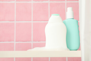 A shelf in the bathroom with care products.