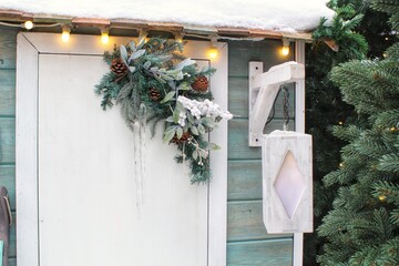 Christmas porch decoration idea. House entrance with lantern decorated for holidays. New year...