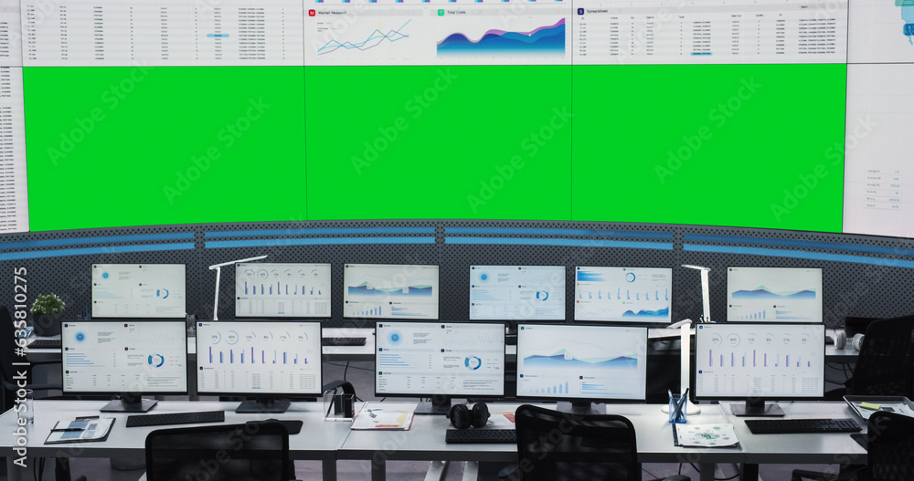 Aufkleber Empty Monitoring Office With Green Screen Chromakey On Big Digital Screen. Desktop Computer Monitors Of Employees Showing Graphs And Charts. Mockup Template Of Successful Financial Analytics Company.