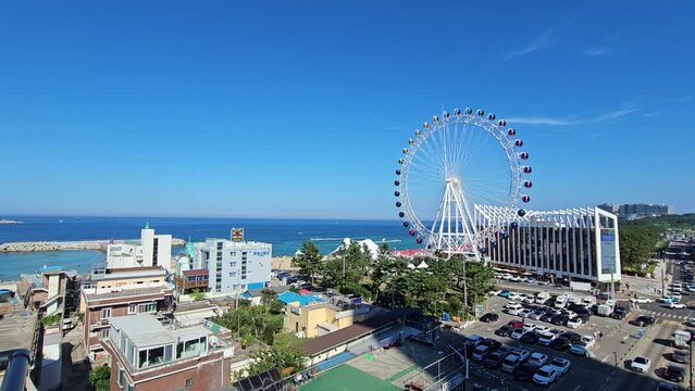 Sokcho Eye Ferris Wheel In Sokcho Crowded City Center in Hot Summer Season, South Korea - Elevated wide angle view