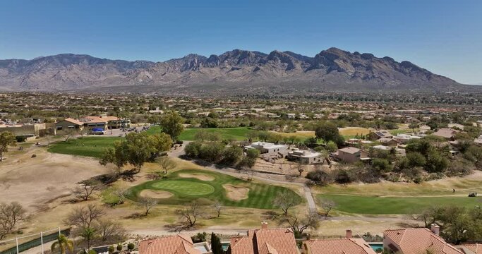 Tucson Arizona Aerial v4 low flyover Oro Valley Canada Hills residential neighborhoods capturing El Conquistador golf course overlooking at desert mountainscape - Shot with Mavic 3 Cine - March 2022