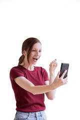 Fototapeta premium A young woman cheerful smiling standing and used smartphone