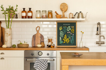 Creative composition of kitchen interior with mock up poster frame, silver oven, tap, stylish cup,...