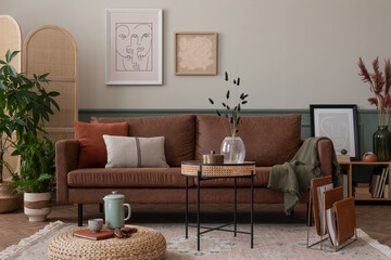 Warm and cozy composition of living room interior with mock up poster frame, brown sofa, beige rug, orange coffee table, wooden partition wall and personal accessories. Home decor. Template.