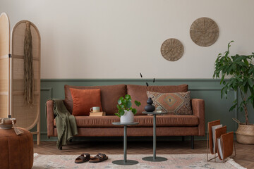 Warm composition of cozy living room interior with brown sofa, orange pillow, wooden partition...